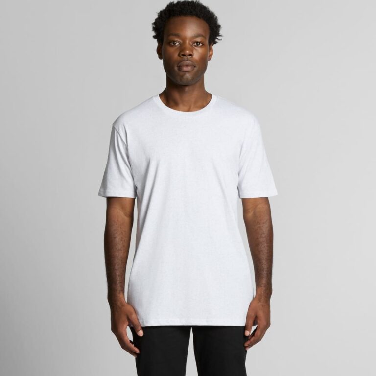 A plain white t-shirt with short sleeves, featuring a logo on the front, modelled by a person standing against a neutral background.