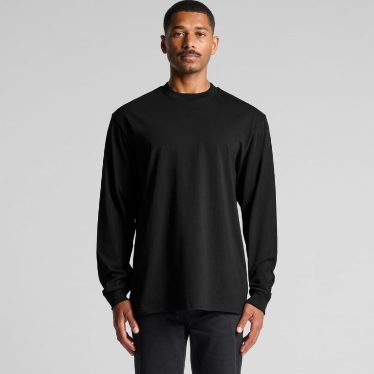 A black long-sleeve t-shirt features a simple design and a logo. The model stands against a neutral background.