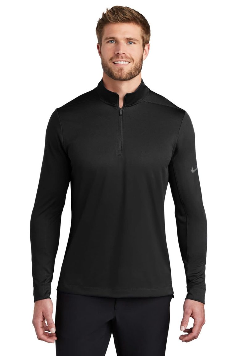 A black half-zip cover-up featuring long sleeves and a logo on the sleeve.