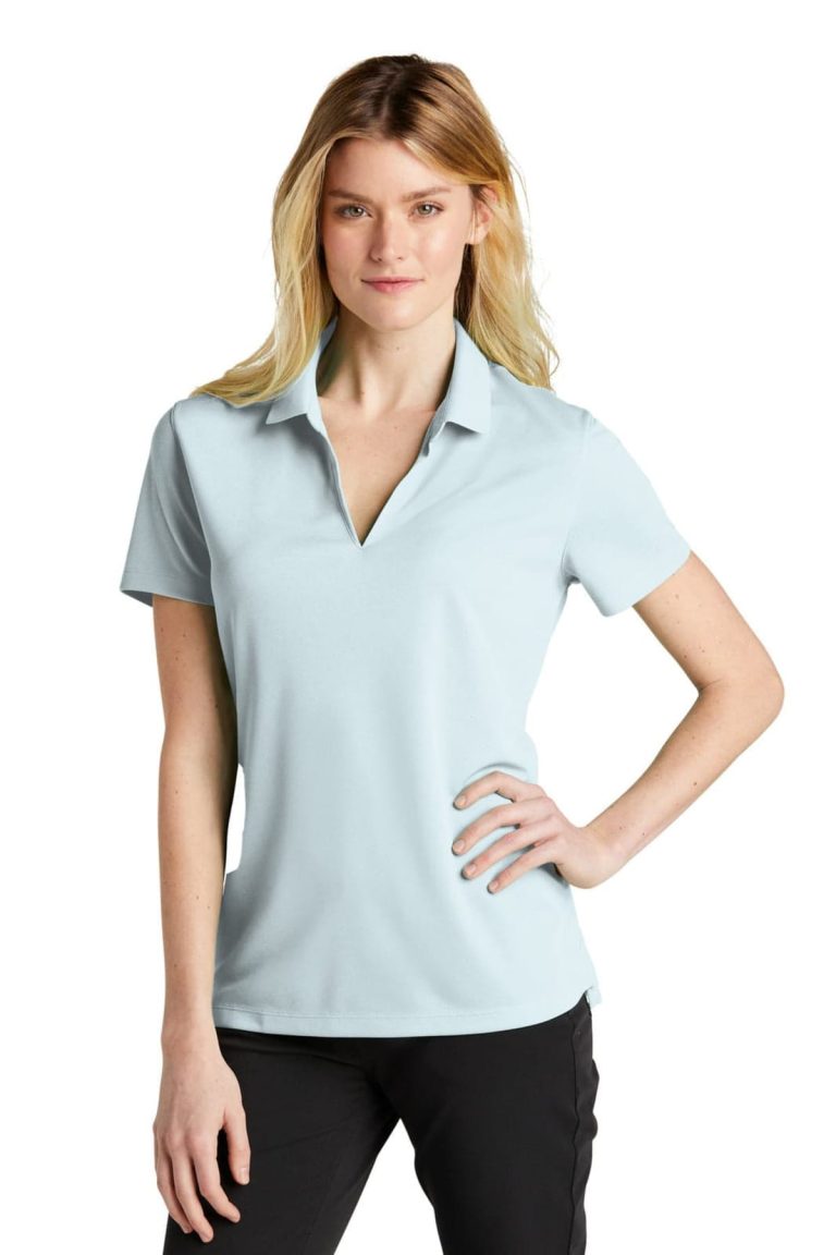 A light blue ladies' polo shirt with a collar and a logo, displayed on a female model.